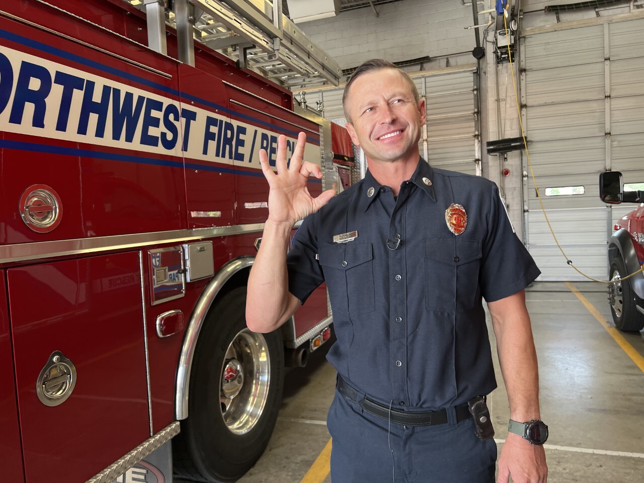 Former Arizona swimmer Greg Owen flashes Wildcat sign he helped create