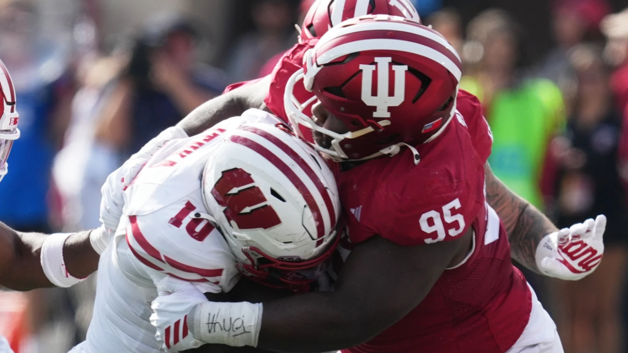 Wisconsin running back Gideon Ituka (10) is tackled by Indiana defensive lineman Tyrique Tucker (95) during the first half of an NCAA college football game against Indiana, Saturday, Nov. 15, 2025, in Bloomington, Ind.