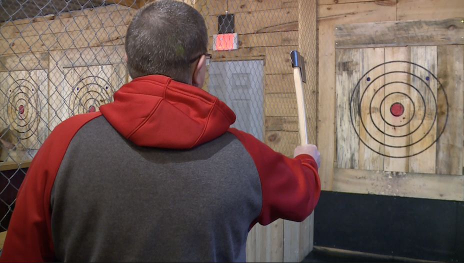 John Petrick enjoys axe-throwing with his team at The Woodshed