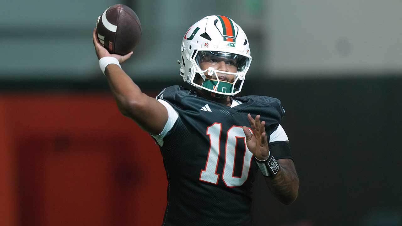 Miami quarterback Darian Mensah (10) throws a pass during a practice session at their training facility, Tuesday, Aug. 4, 2026, in Coral Gables, Fla.