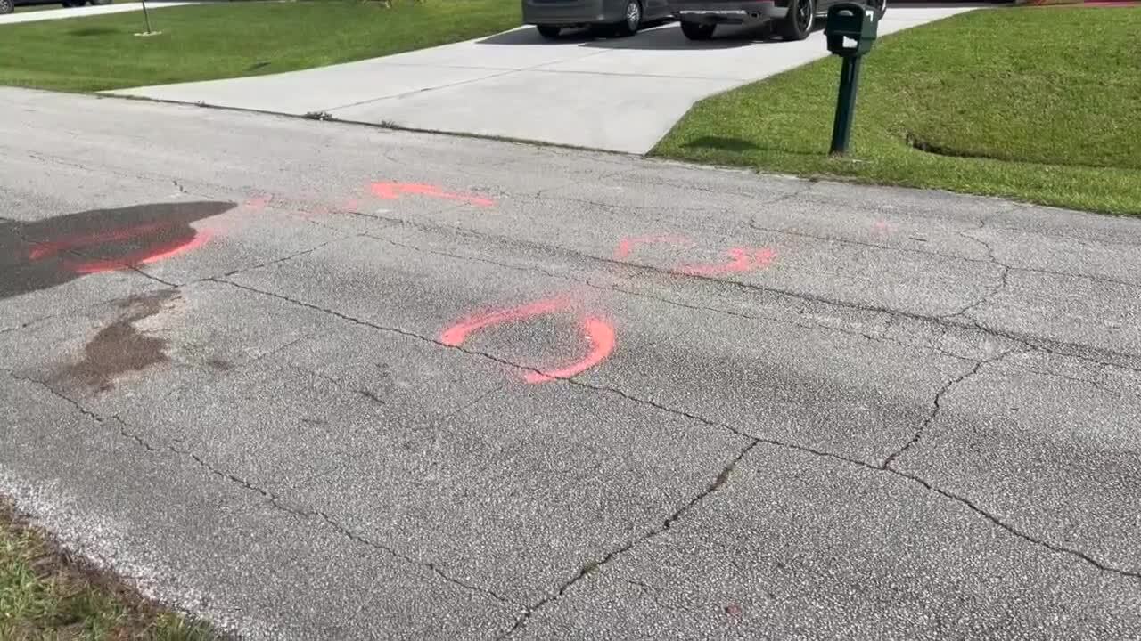 Police markings on roadway where man shot in vehicle in Port St. Lucie, July 14, 2022