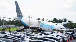 Workers inspect an Amazon cargo plane two days after it overshot a runway at Miami International Airport, Tuesday, Sept. 8, 2026, in Miami. 