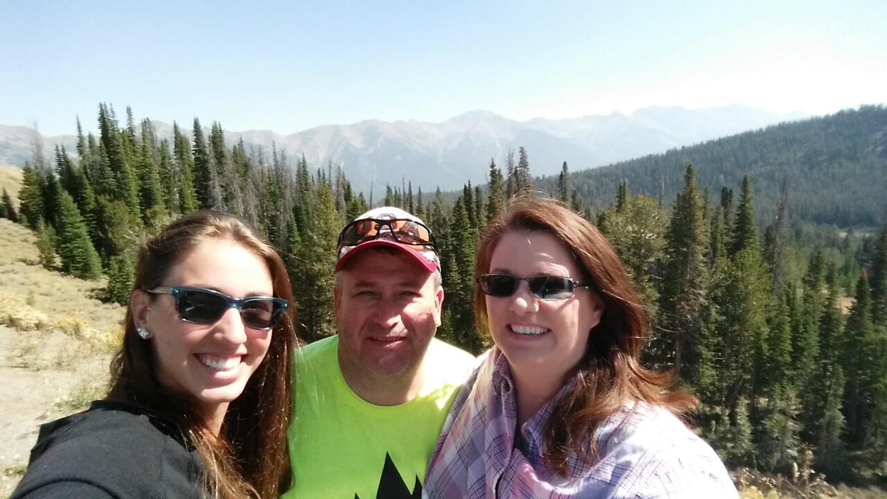 Deedra Irwin poses for a photo with her mom and dad