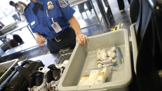 Shoes and small liquid containers are placed in bins to be screened by TSA Supervisor Jennifer Haslip at the x-ray machine at Washington's Ronald Reagan National Airport, Friday, June 27, 2008. 