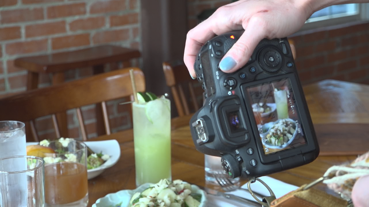 Amanda Light takes pictures of the dinner dish at Ronin
