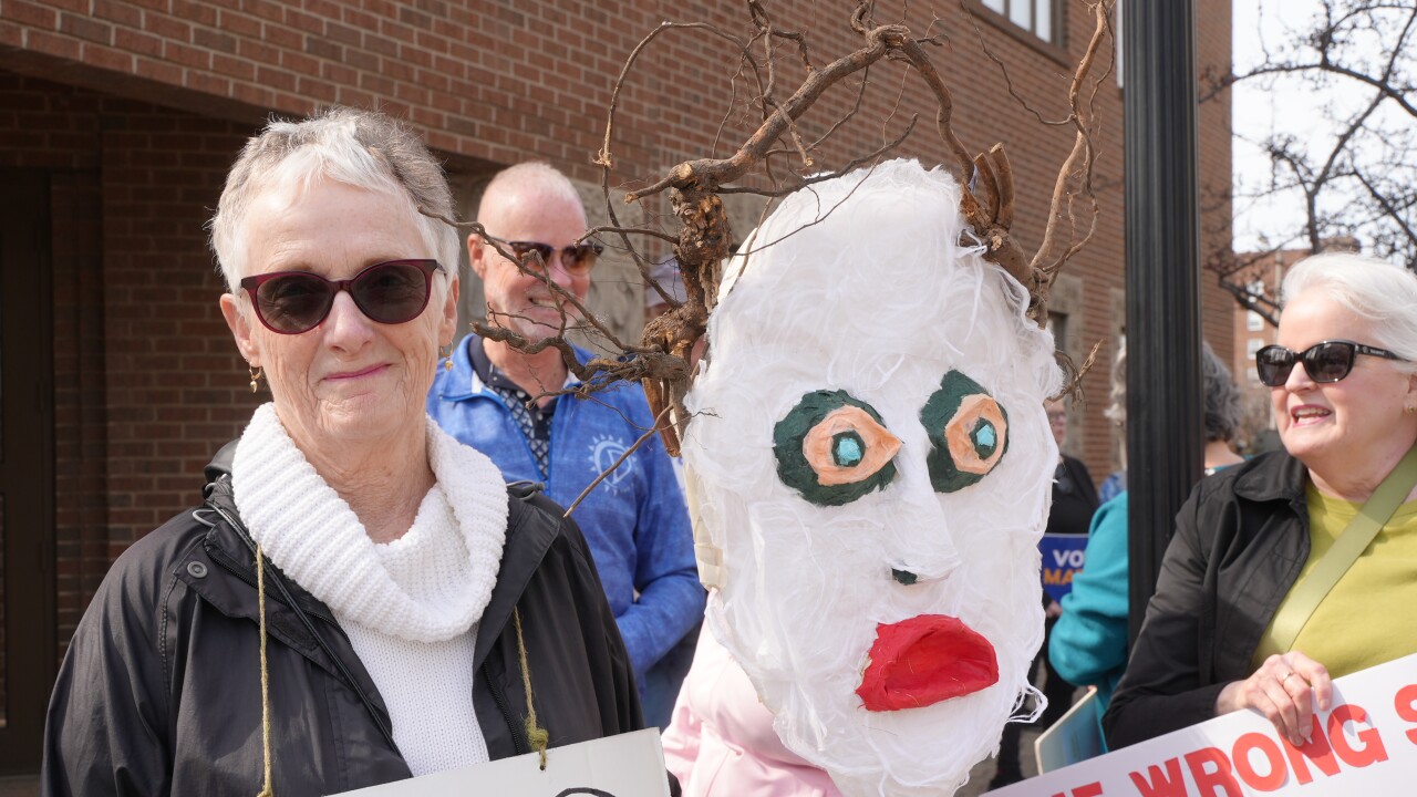 Protest outside of Rep. Bill Huizenga's office in Holland