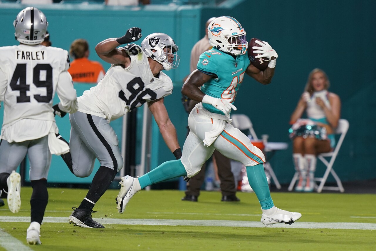 Miami Dolphins running back ZaQuandre White scores TD as Las Vegas Raiders defensive end Tashawn Bower late to make tackle in preseason game, Aug. 20, 2022