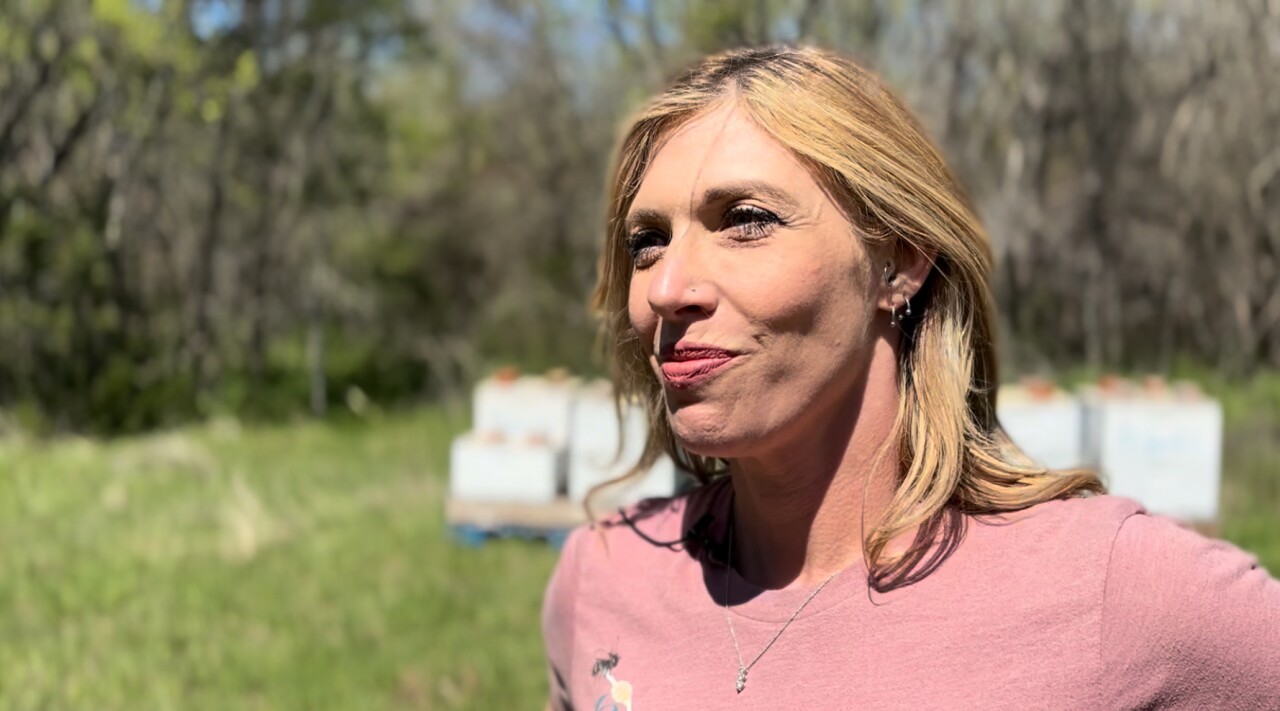 Melinda Richardson Sheffield outside of some of her honey bee colonies. 