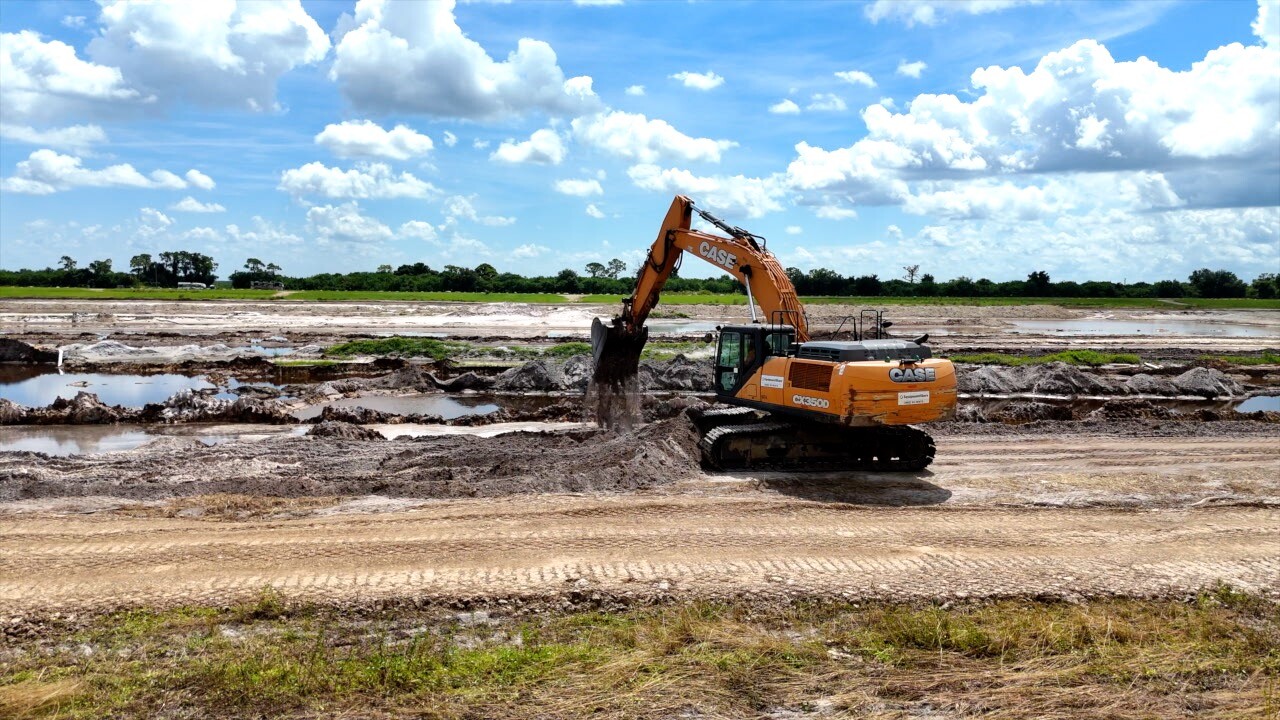 Excavator busy digging the reservoir, the final phase of the 100-acre project.