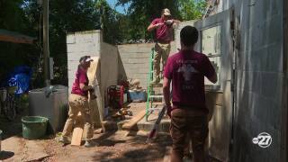 Volunteers restore building.jpeg