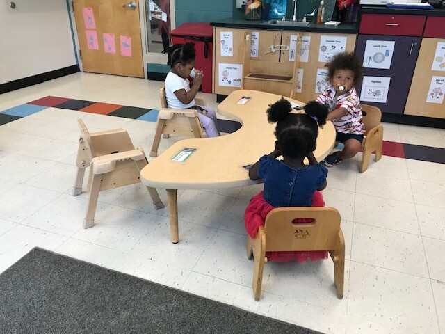 Students sitting at a table at a daycare in Milwaukee County