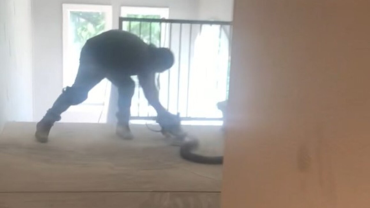 Worker sanding at Mountain Gate apartments