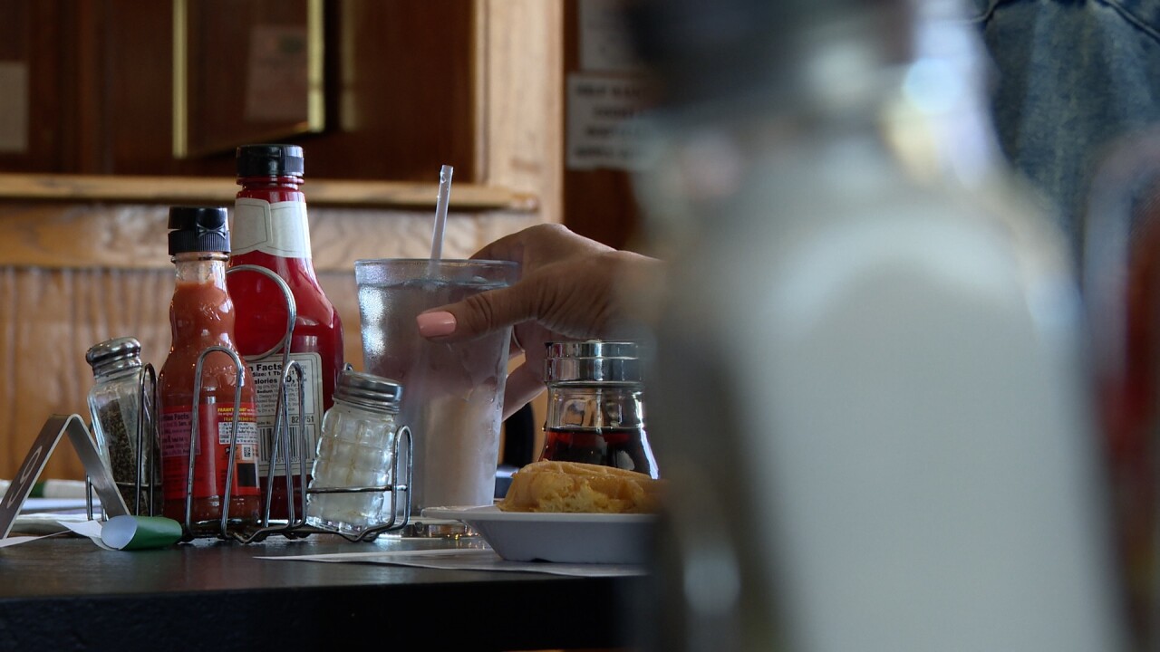 Woman grabs a drink at a Lansing neighborhood restaurant