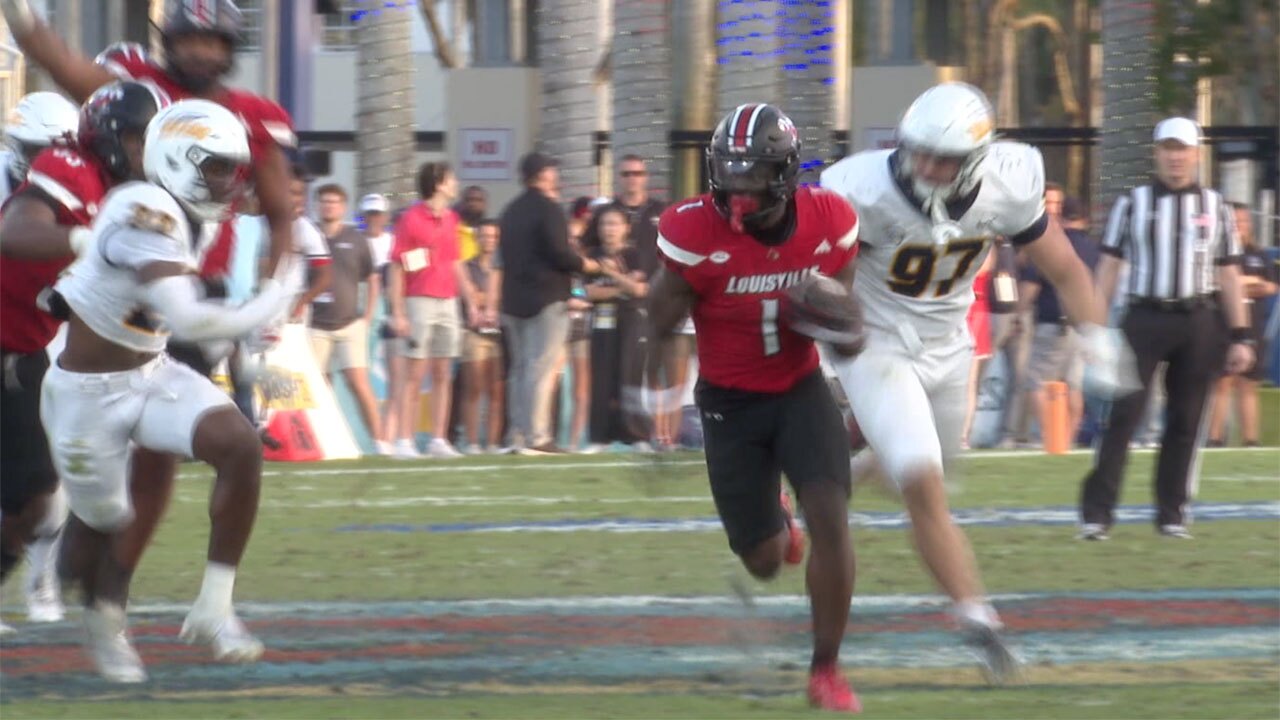 Isaac Brown of the Louisville Cardinals runs for a touchdown against the Toledo Rockets at the Boca Raton Bowl in Boca Raton, Fla., on Dec. 23, 2025.