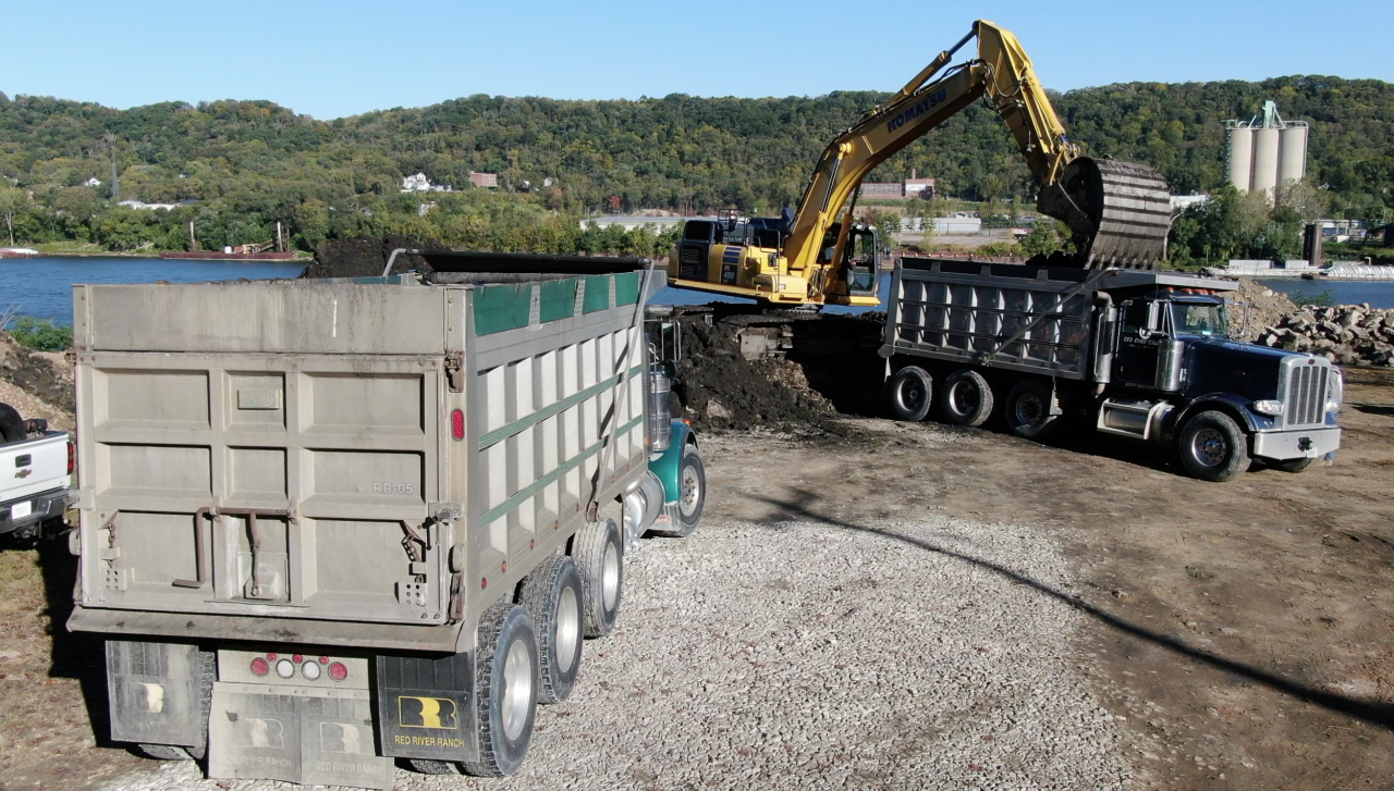 SKY 9 shows workers loading contaminated waste into dump trucks on the Bells' property