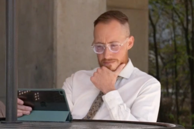 Colorado attorney Zachariah Crabill stares at a tablet.