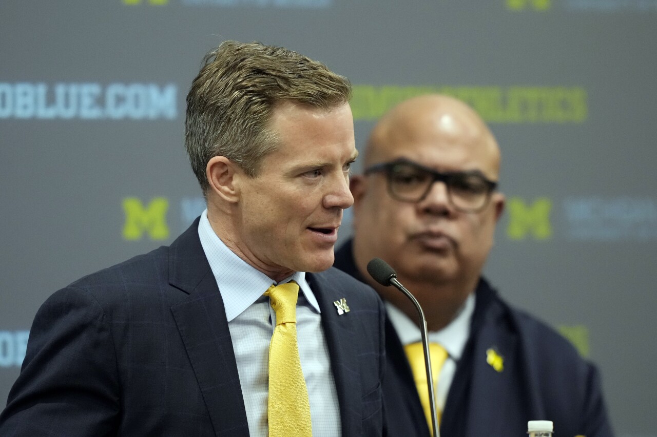 Michigan Wolverines basketball coach Dusty May speaks as Warde Manuel listens during introductory news conference, March 26, 2024