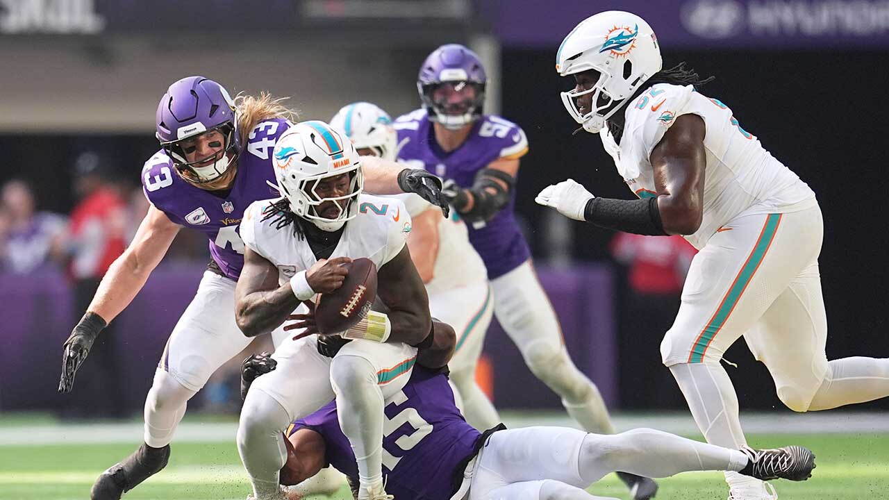 Miami Dolphins quarterback Malik Willis (2) is sacked by Minnesota Vikings linebacker Dallas Turner (15) during the first half of an NFL football game Sunday, Oct. 4, 2026, in Minneapolis. (AP Photo/Abbie Parr)