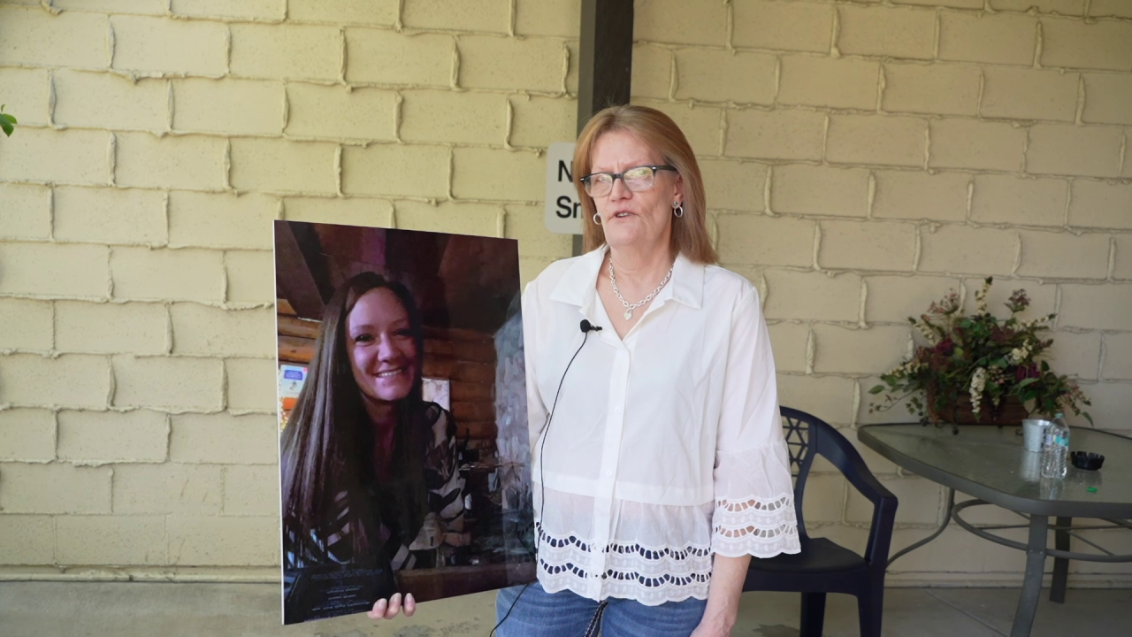 Ginger Benson holds a picture of her daughter Sarah