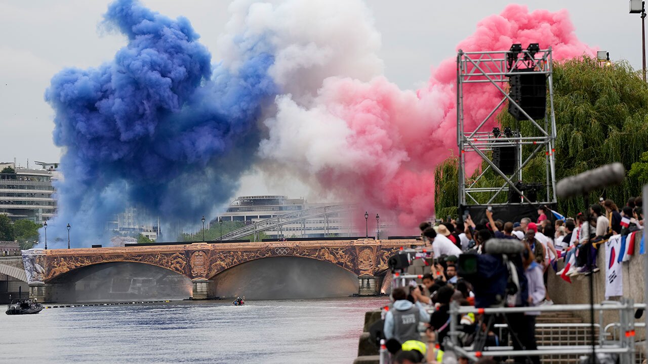 Smoke in the colours of the French flag billows in Paris, France, during the opening ceremony of the 2024 Summer Olympics, Friday, July 26, 2024.