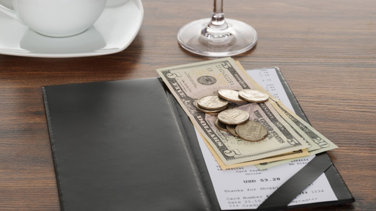 Cash tip sitting on a restaurant table.