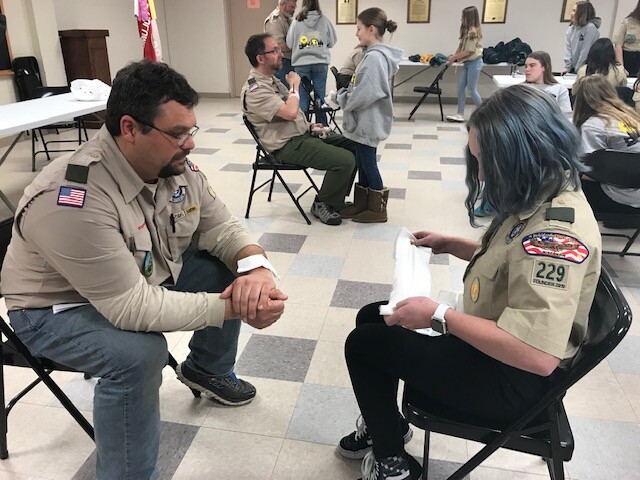 Scout Master and scout go through badge training in Mukwonago