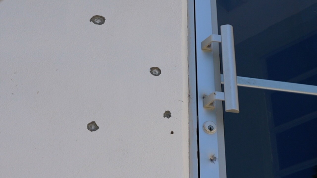 Bullet holes on the door and wall of Clewiston's Community Christian Church.