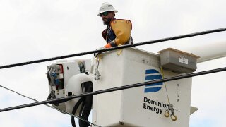  A Dominion Energy lineman lifts himself up to work on a power line in the aftermath of Hurricane Helene Sunday, Sept. 29, 2024, in North Augusta, S.C. 