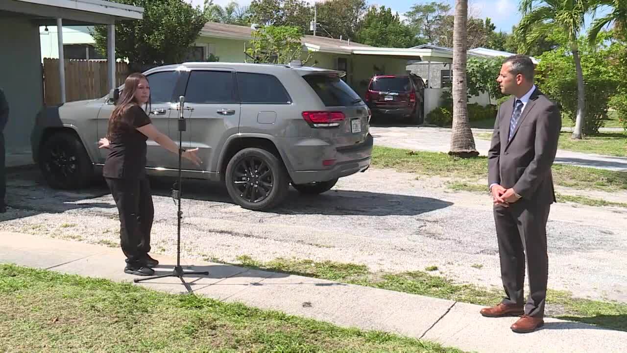 Sandy Martinez points to the driveway and sidewalk outside her Lantana home that led to more than $100,000 in parking fines