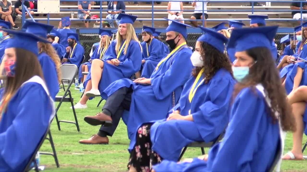 Martin County High School class of 2020 sit in chairs on football field for graduation ceremony