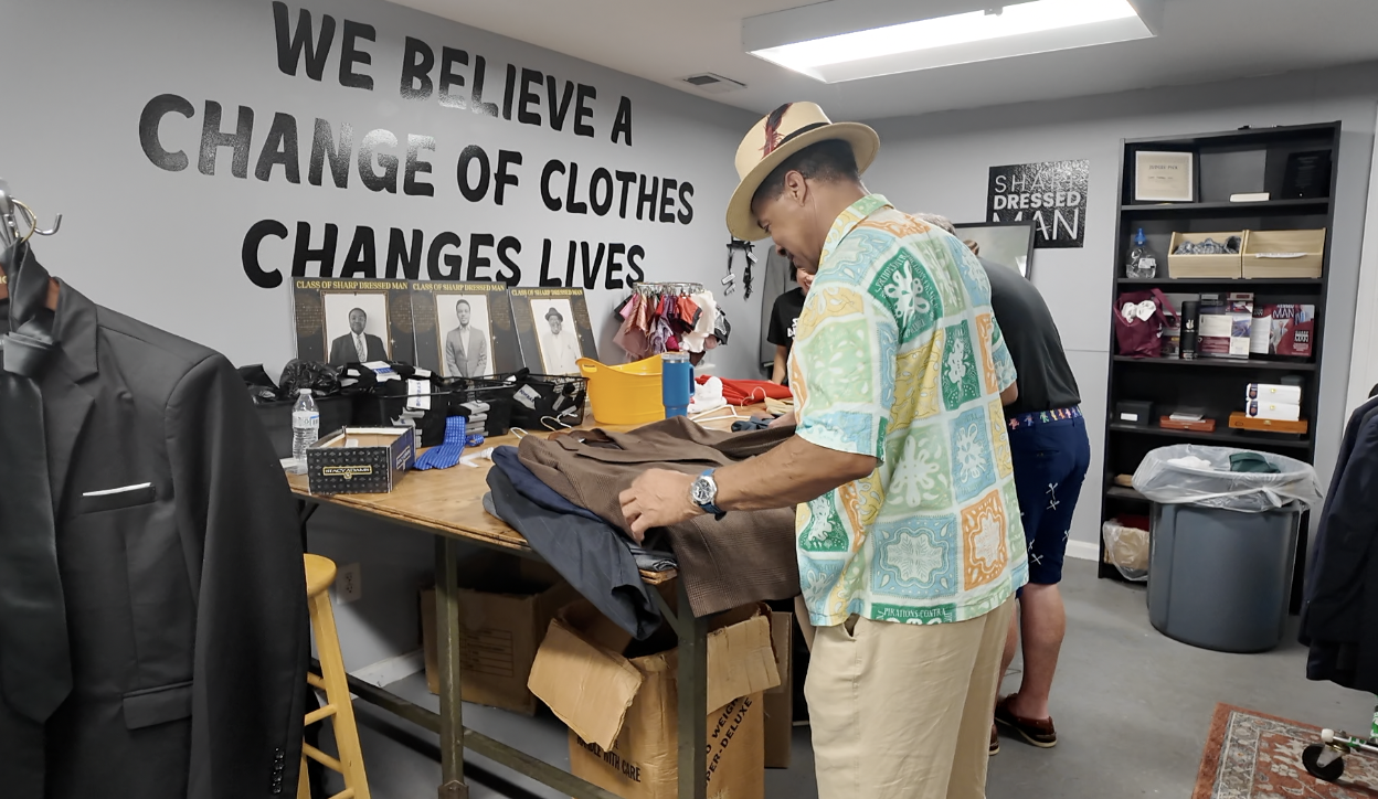 Volunteers sorting suit jackets