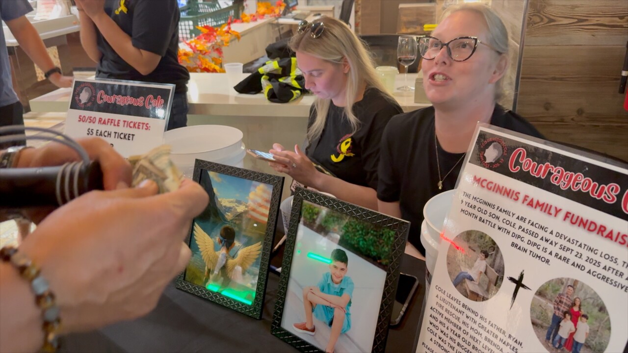 Community members run a booth to raise money for Cole McGinnis. 