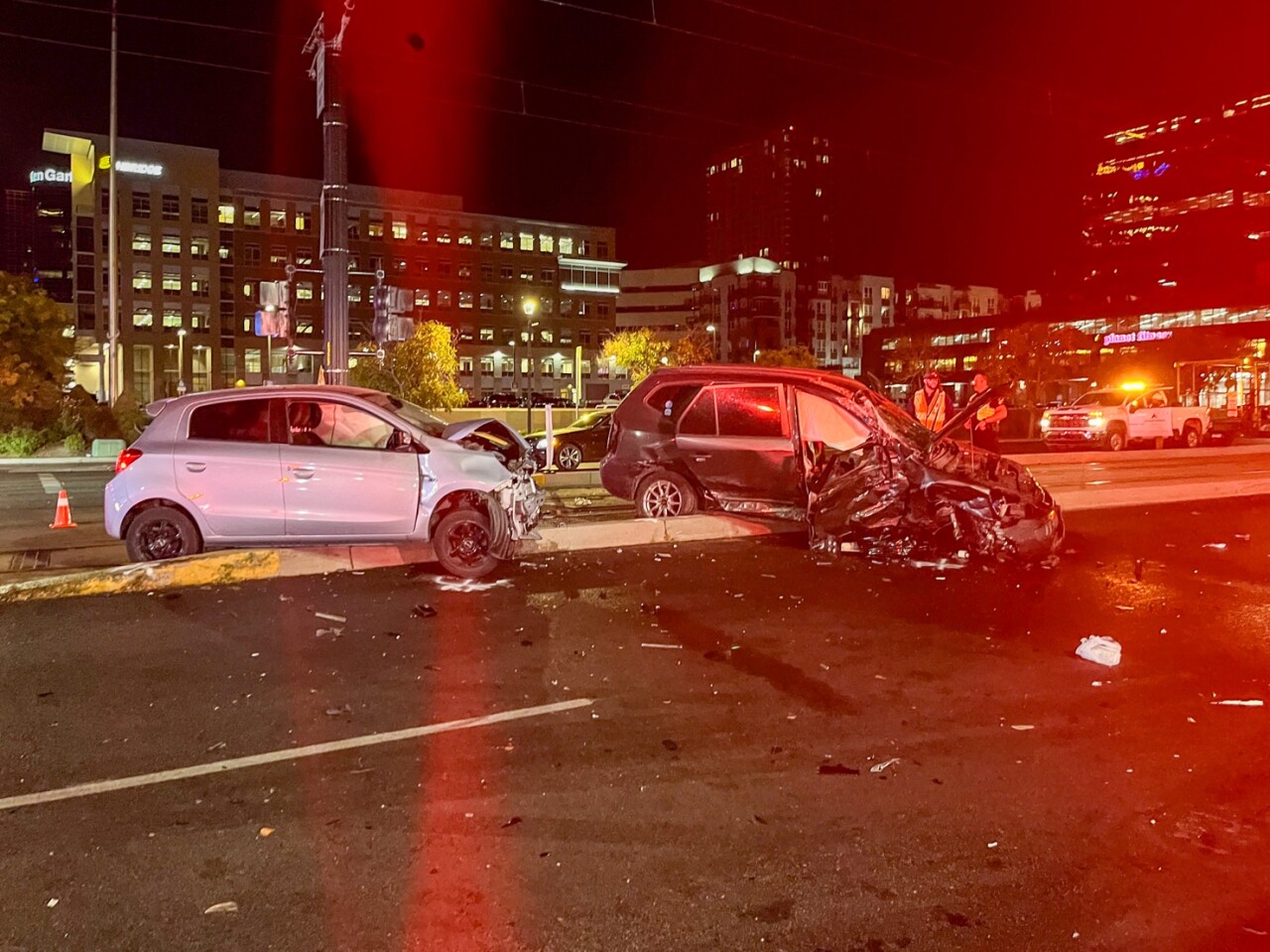 A photo of the scene released by Salt Lake City Police. It's nighttime, and two heavily damaged cars are on the UTA TRAX line that runs along 400 South. Debris is strewn about the road.