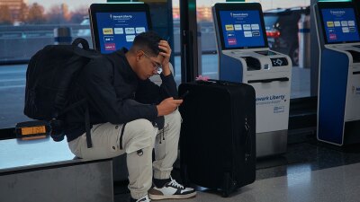 A passenger flying with Arajet to Santo Domingo waits to check in at Newark Liberty International Airport on Friday, Nov. 7, 2025 in Newark, N.J. (AP Photo/Andres Kudacki)