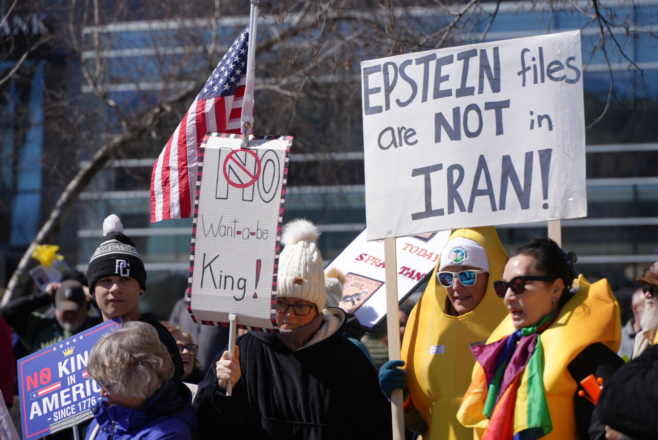 No Kings protester holding a sign reading Epstein files are not in Iran in Grand Rapids Michigan