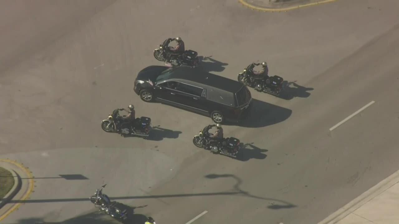 FHP motorcyclists surround hearse carrying body of Trooper Zachary Fink during funeral procession, Feb. 12, 2024