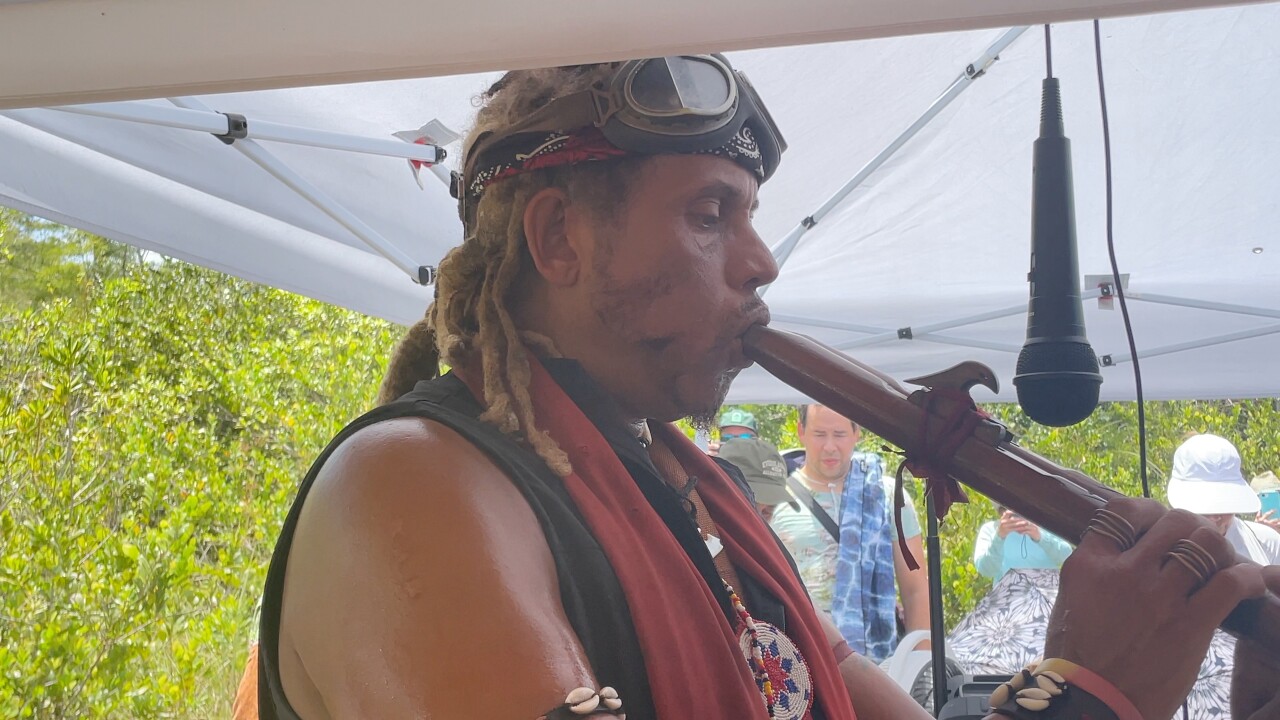 Ant Hatcher plays flute at faith service.