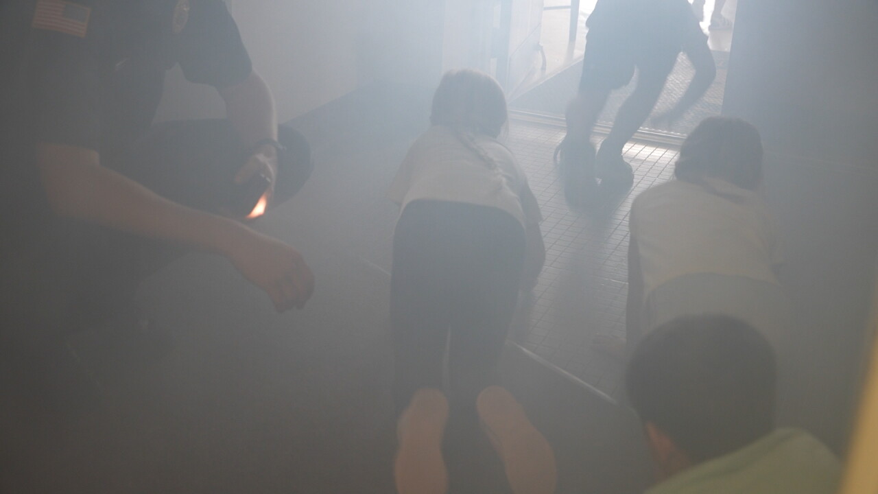 students crawling smoke