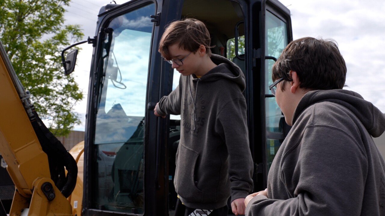 Kid climbing out of excavator