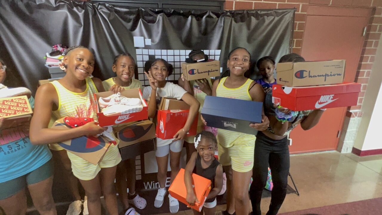 Students receive pairs of shoes