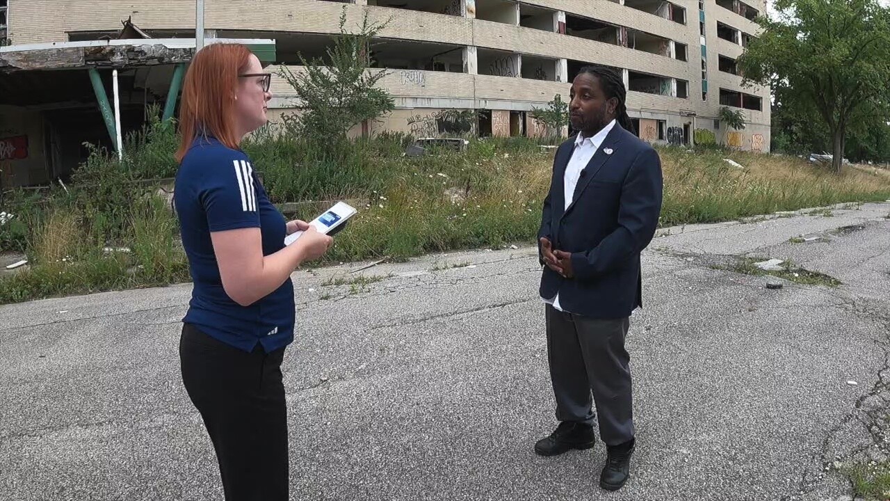East Cleveland Mayor Brandon King talks to News 5 reporter Michelle Jarboe outside the vandalized apartment tower.
