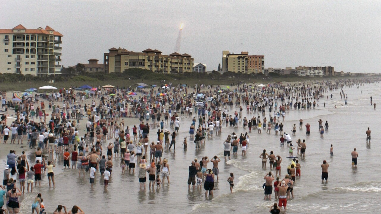 Spectators gather on Cocoa Beach to watch launch of space shuttle Atlantis in 2011