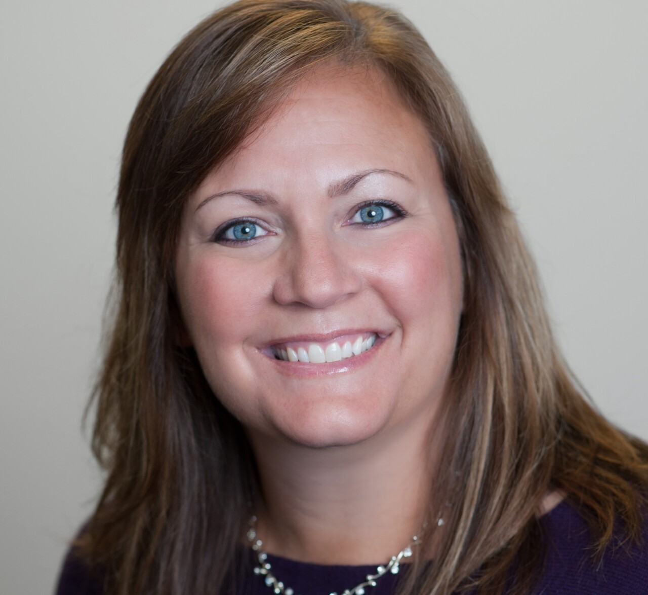 Jodi Harding is the chief operations officer at Lighthouse Youth and Family Services. In this photo, she is wearing a dark top and a necklace with white beads.