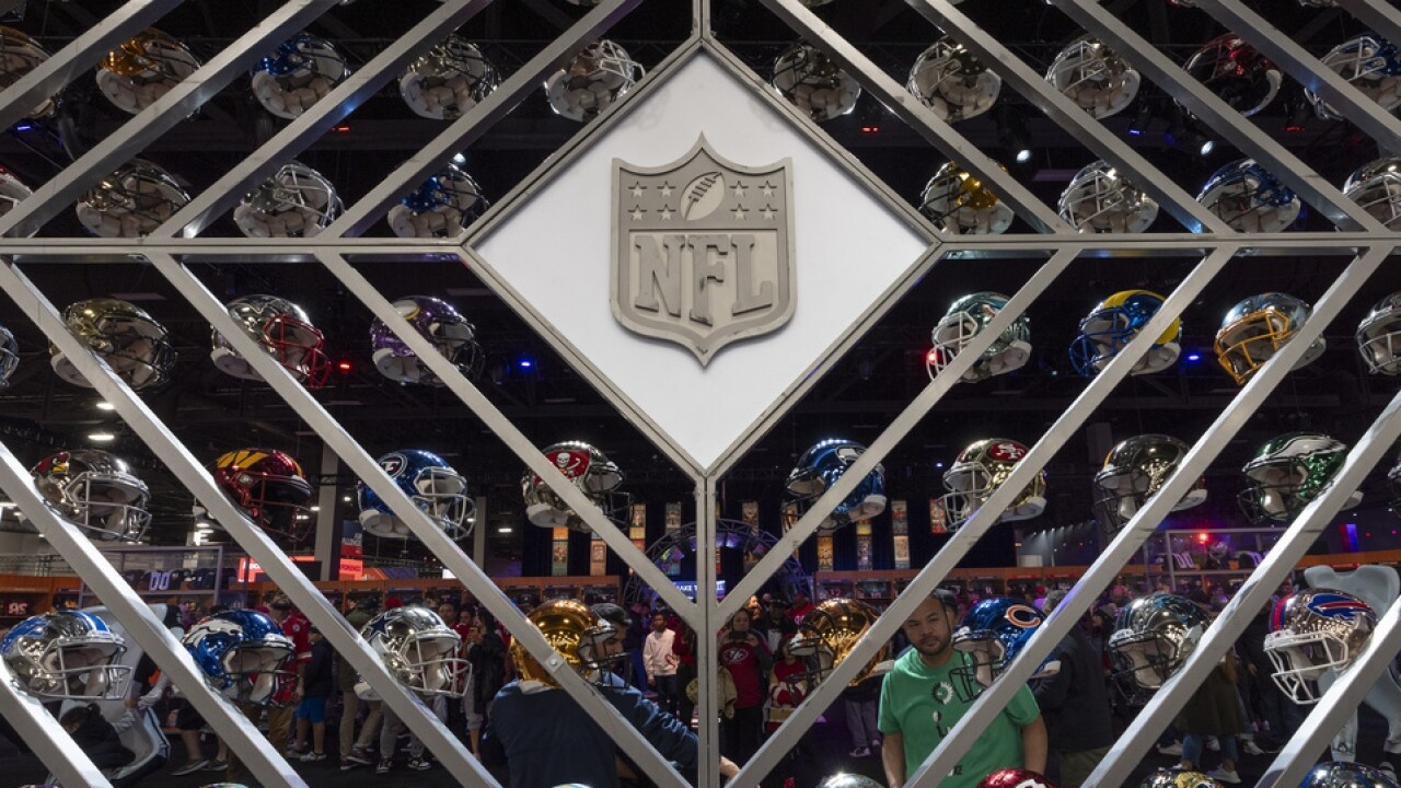 Display of football helmets representing all 32 NFL teams.