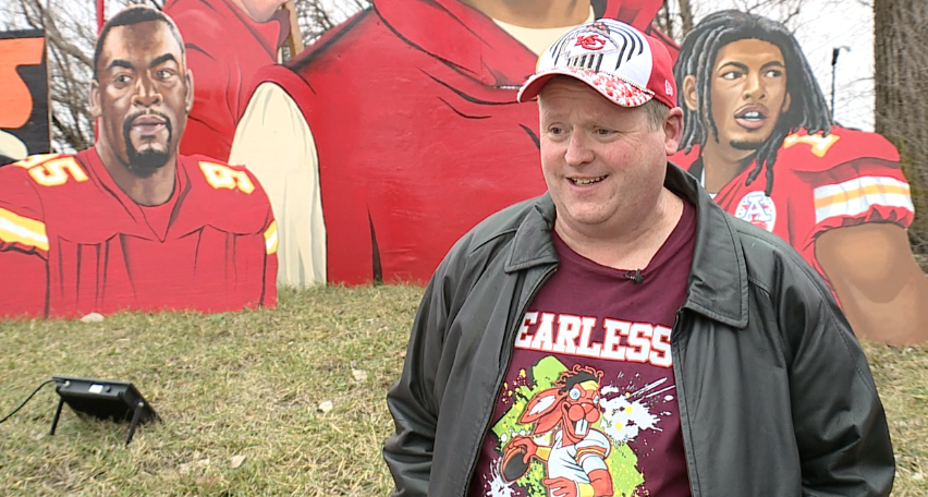Jeff Parson in front of his artwork
