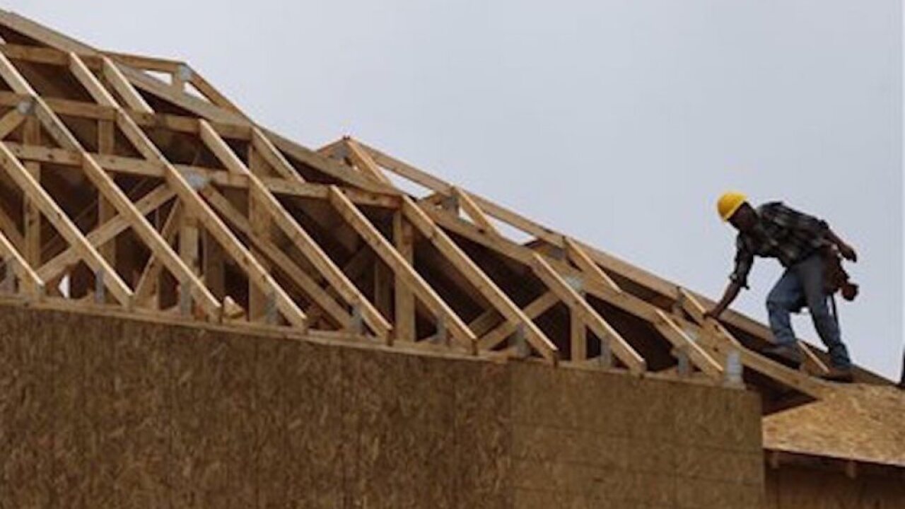 Builders work on a large luxury home in Roswell, Georgia.