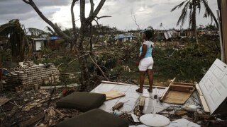 A Puerto Rico resident looks at damage caused by Hurricane Maria