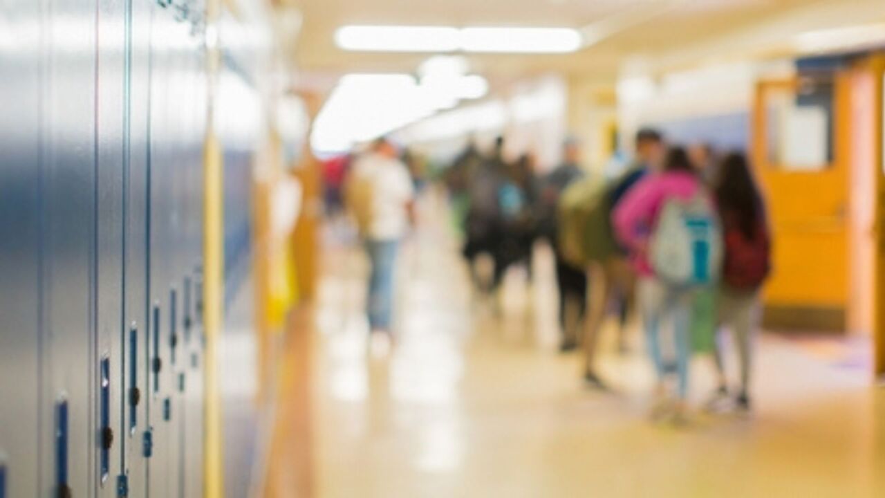 Stock image of a school hallway with lockers.