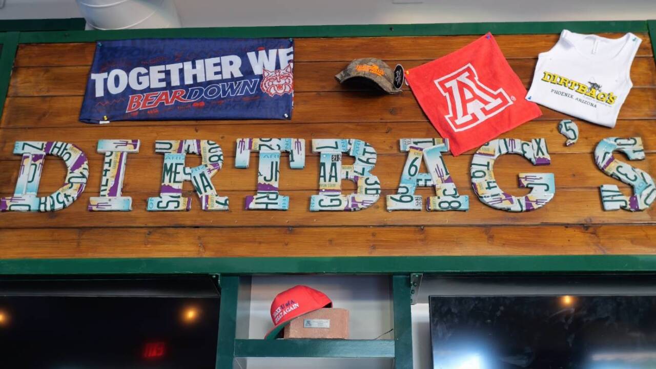A close-up of the University of Arizona and Dirtbag’s things hanged on the wall of the bar area.