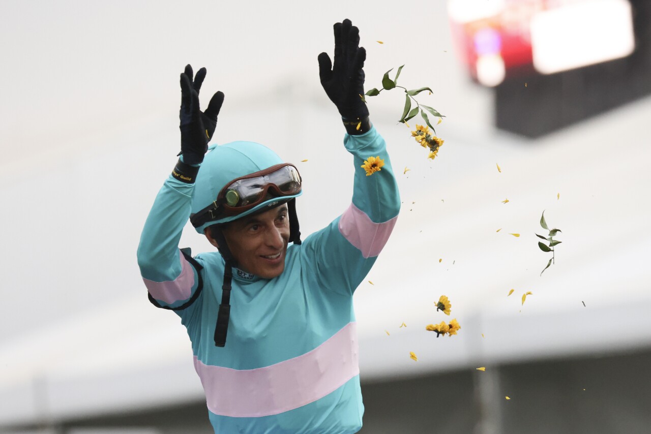 John Velazquez, atop National Treasure, tosses Black-Eyed Susan flowers celebrates after winning the148th running of the Preakness Stakes horse race at Pimlico Race Course, Saturday, May 20, 2023, in Baltimore. (AP Photo/Julia Nikhinson)